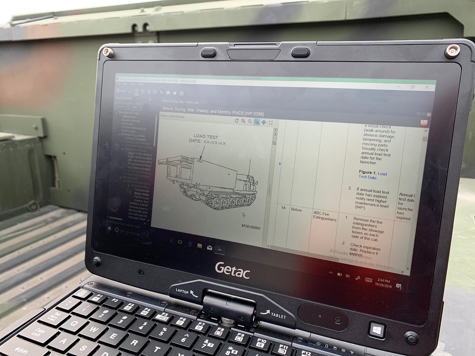 An electronic technical manual open on a rugged field laptop